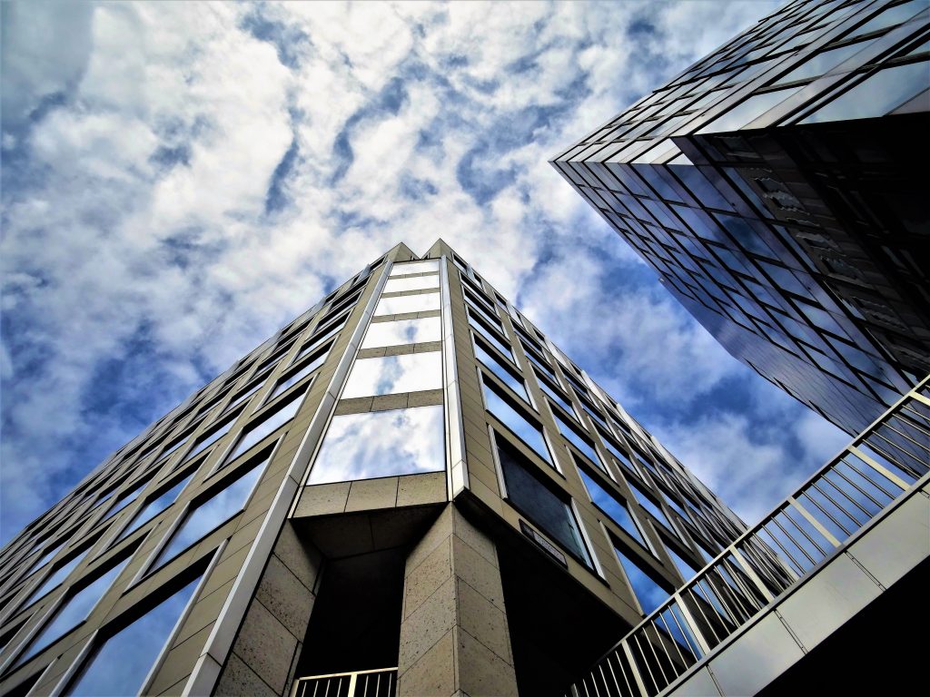 Modern commercial office buildings representing Shared land ownership, micro-investing in land, opportunities to buy shares of land, fractional raw land, and shared acreage buying through professionally managed real estate investments.